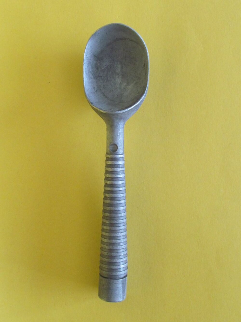Vintage aluminum ice cream scoop with a ribbed handle